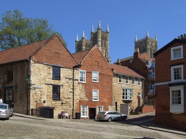 Historic buildings along Bailgate in Lincoln, with cathedral towers behind